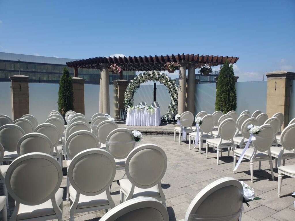 Outdoor wedding ceremony setup with chairs, aisle decor, and natural scenery at our venue.