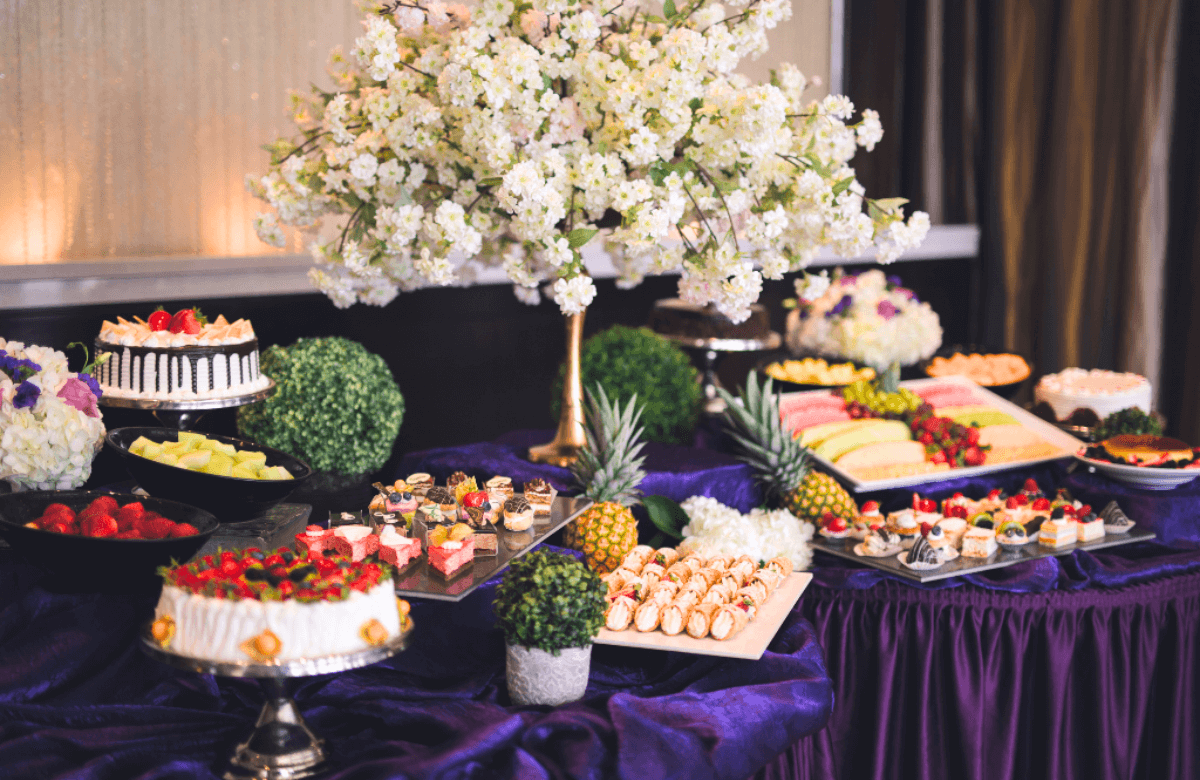 A large, beautifully decorated hall set up for a wedding reception.