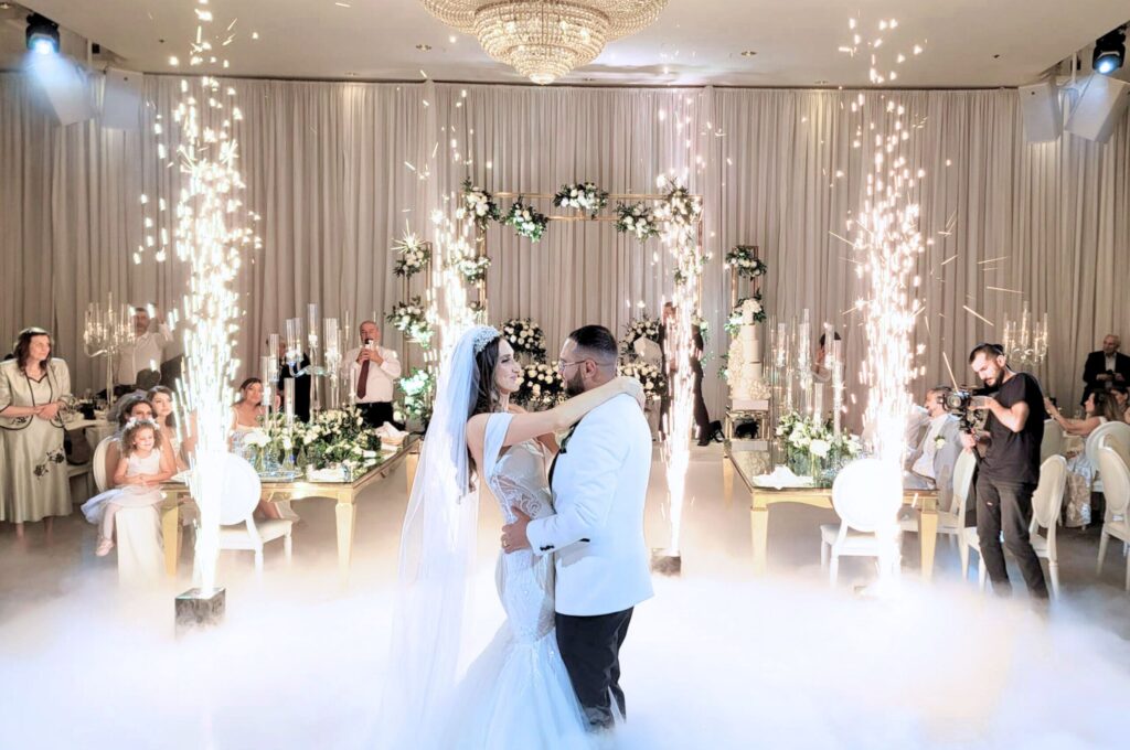 Bride and groom exchanging vows in our elegant Mississauga wedding venue with floral arch decor.