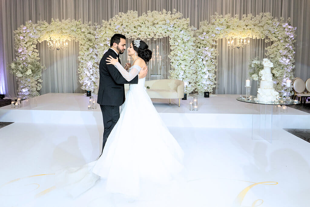 Newlyweds cutting their wedding cake in our beautifully decorated Mississauga event space.
